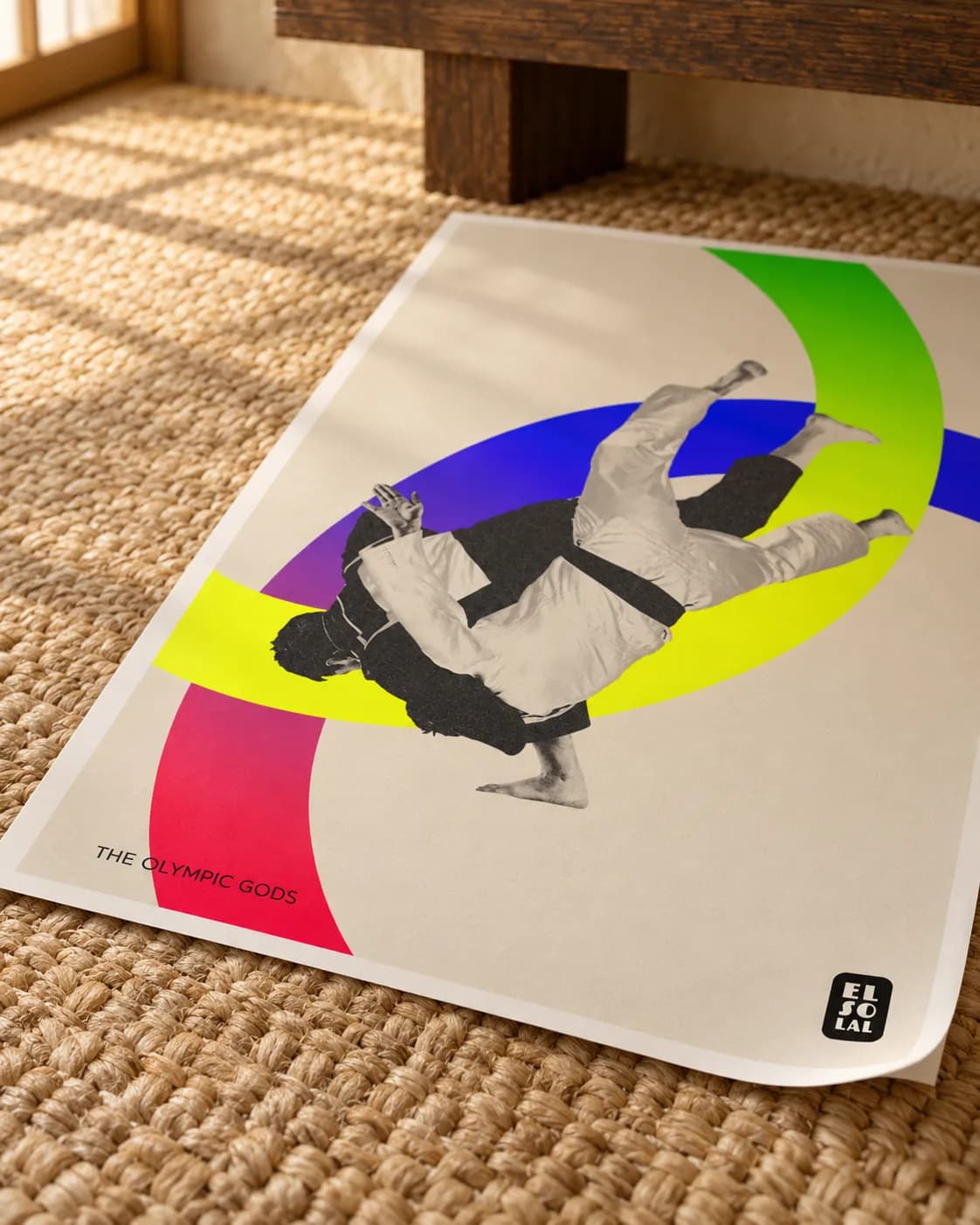 A corner of The Judoka lifting, the grain of the paper in raking light