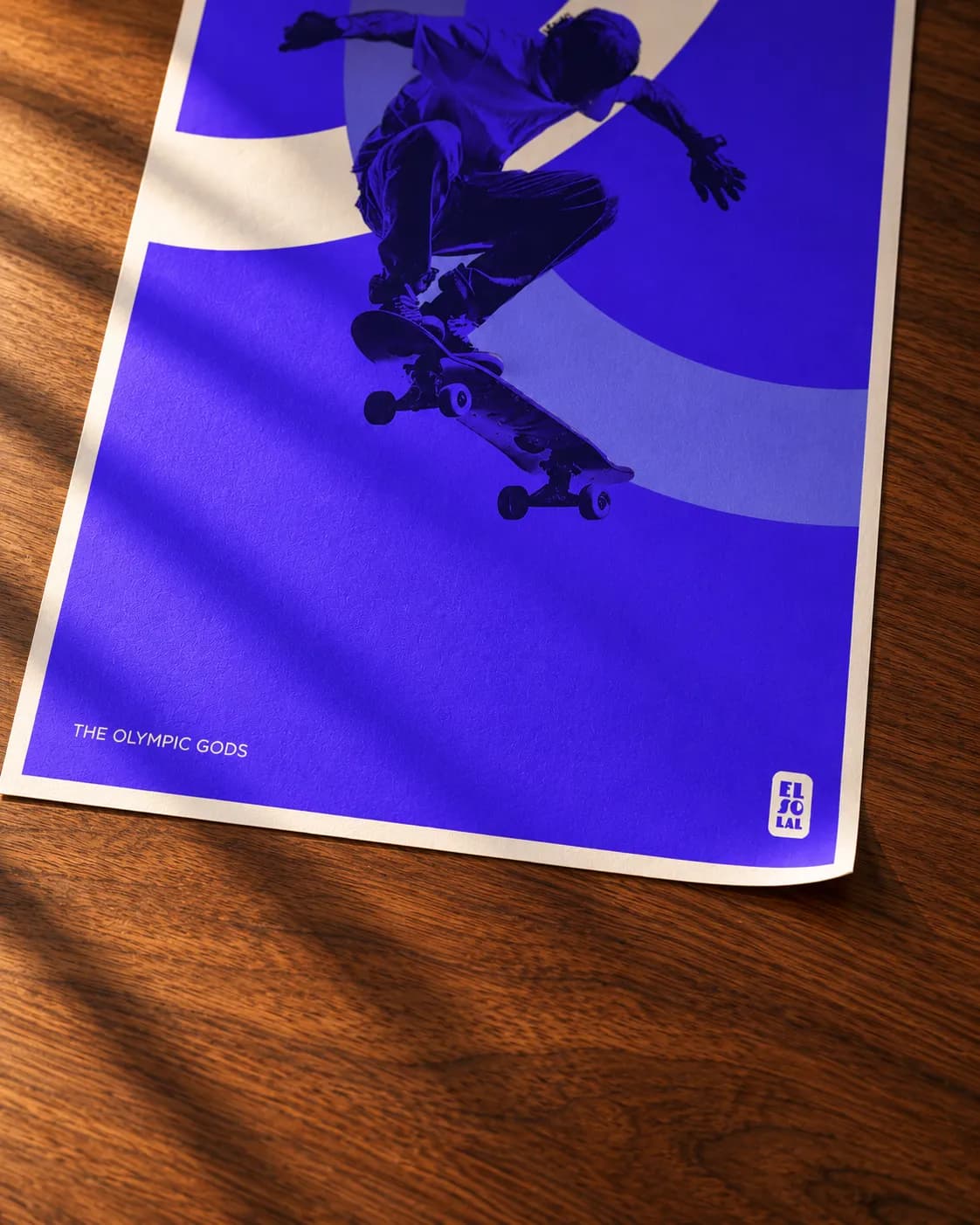 A corner of The Skater lifting, the grain of the paper in raking light